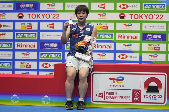 On top: Japan’s Akane Yamaguchi poses with her medal after defeating China’s Chen Yu Fei in their women’s singles final.