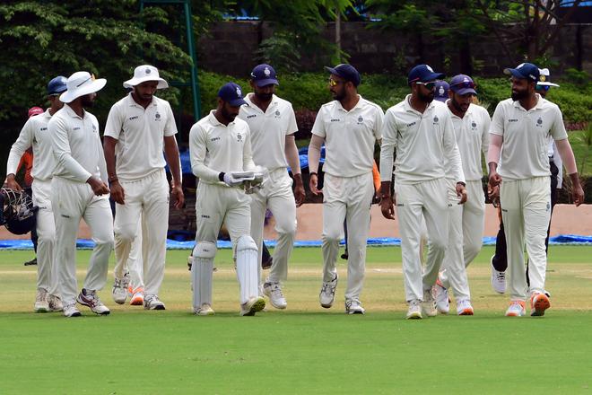 Marching on: Madhya Pradesh players return to the dressing room after completing a 174-run win over Bengal in the Ranji Trophy semifinal in Alur, Bengaluru.