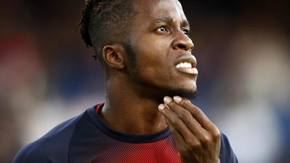 Zaha not happy but will face Everton, says Hodgson