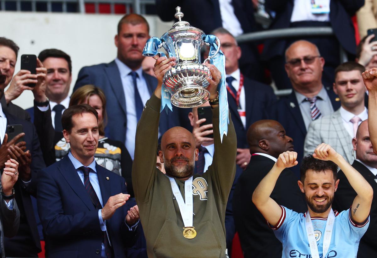 Pep Guardiola lifts the FA Cup Trophy after the team’s victory against Manchester United at Wembley Stadium on June 03, 2023 in London, England.