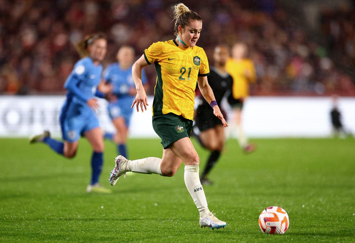 Ellie Carpenter of Australia runs with the ball during the Women’s International Friendly match between England and Australia at Gtech Community Stadium on April 11, 2023 in Brentford, England.