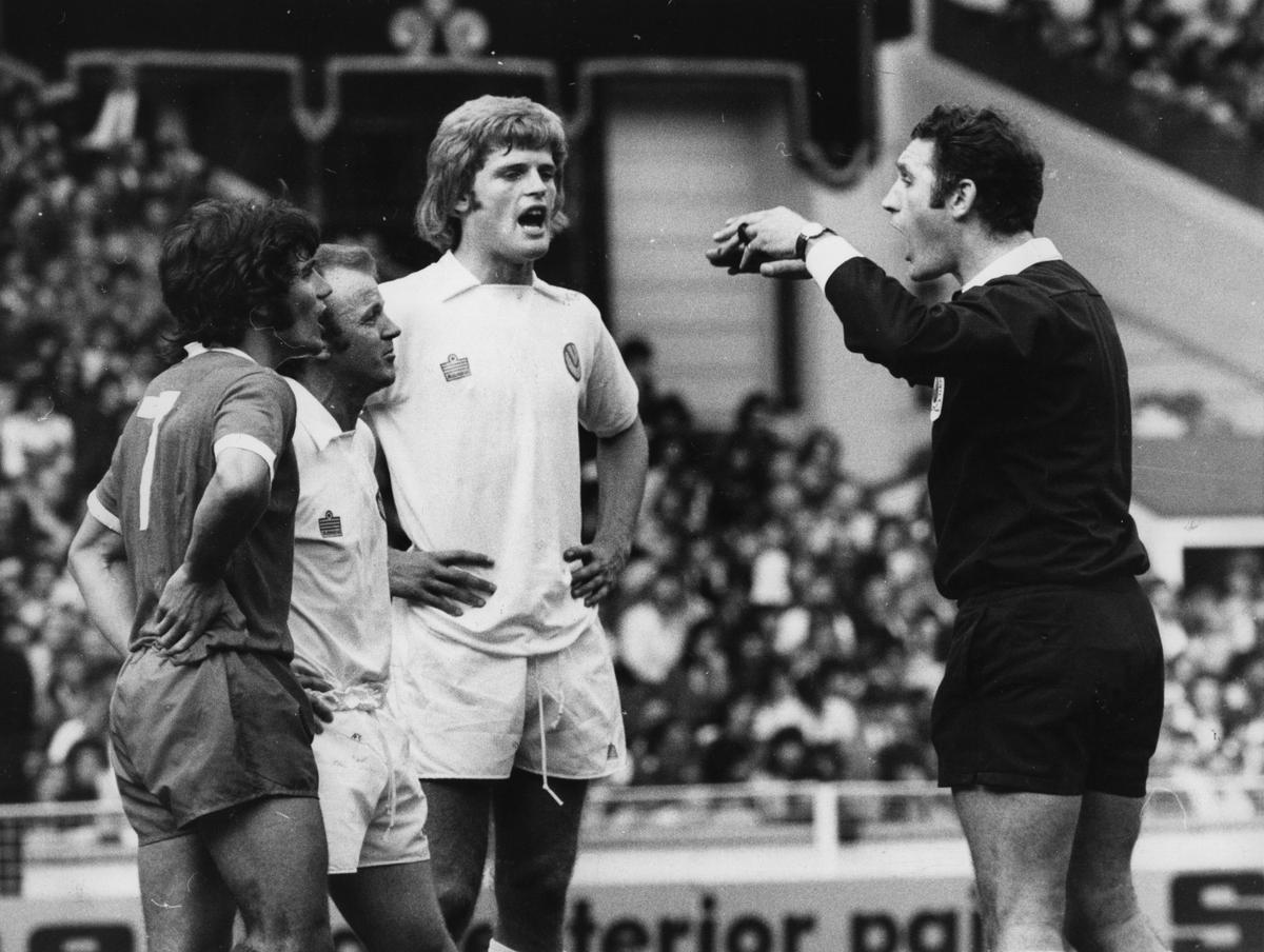 Gordon McQueen (center) of Leeds United FC watches as referee R Matthenson sends off Kevin Keegan from Liverpool FC and Billy Bremner (1942 -1997) of Leeds United FC for trading punches during a testy Charity Shield match at Wembley. 