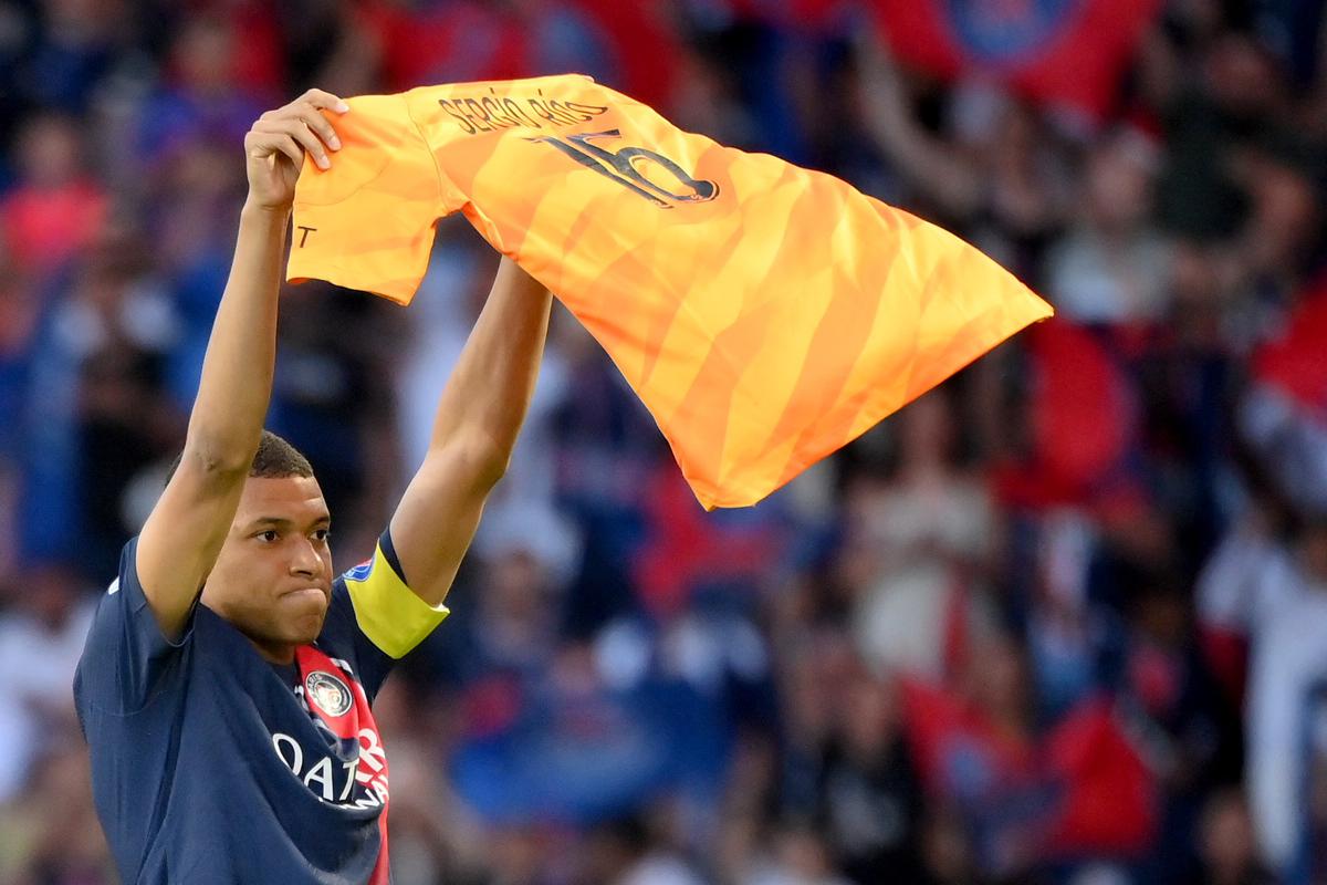 Paris Saint-Germain’s French forward Kylian Mbappe celebrates scoring his team’s second goal with holding up jersey of Paris Saint-Germain’s Spanish goalkeeper Sergio Rico.