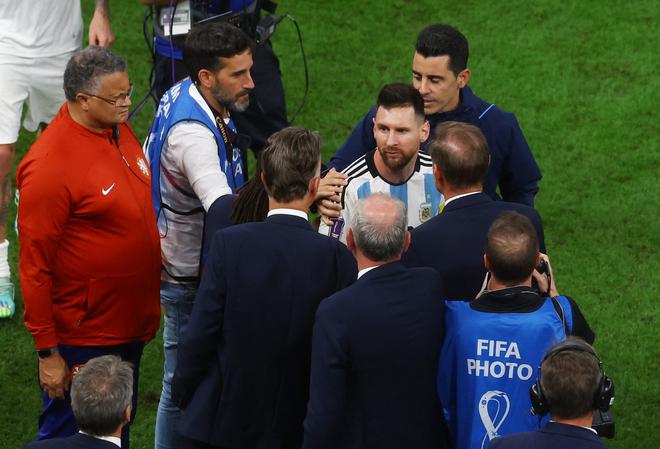 Lionel Messi with Netherlands coach Louis van Gaal and assistant coach Edgar Davids after the penalty shootout as Argentina progress to the semi finals and Netherlands are eliminated from the World Cup.