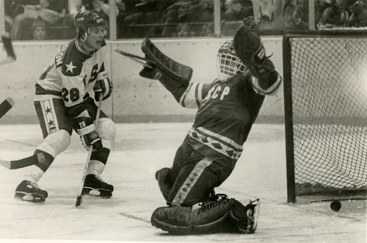 Puck goes past Soviet goalkeeper Vladimir Myshkin to mark the fourth goal for the USA in the ice hockey game in 1980.