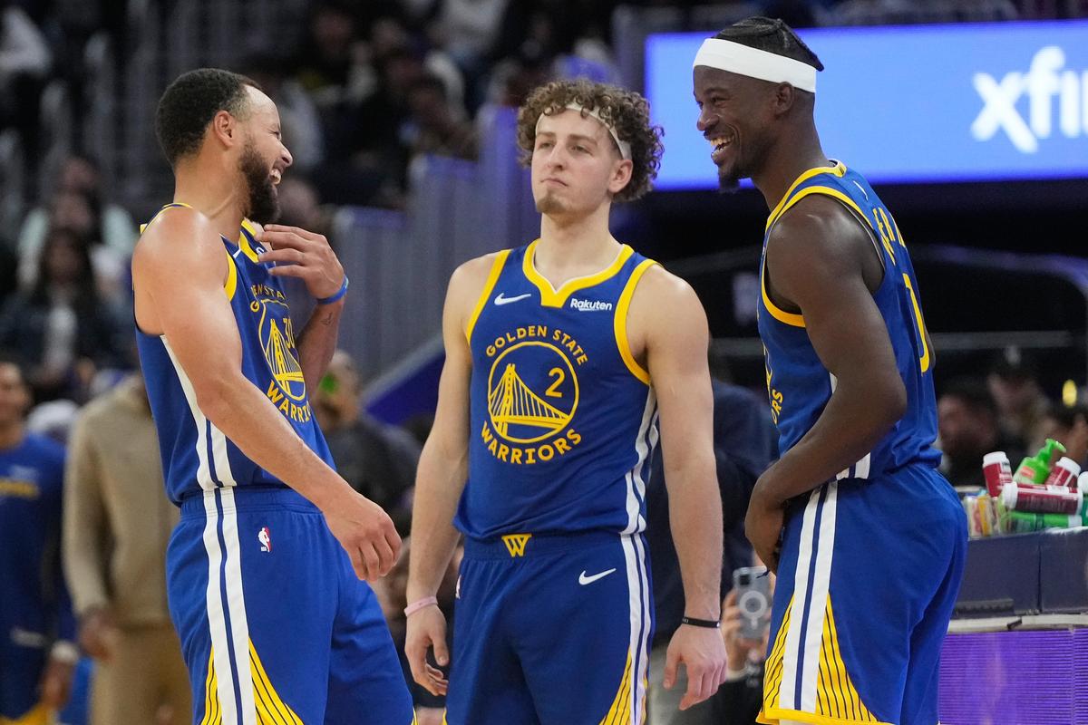 Golden State Warriors guard Stephen Curry laughs next to guard Brandin Podziemski (2) and forward Jimmy Butler III during the second half of the NBA game against the Memphis Grizzlies. Golden State Warriors guard Stephen Curry laughs next to guard Brandin Podziemski (2) and forward Jimmy Butler III during the second half of the NBA game against the Memphis Grizzlies.