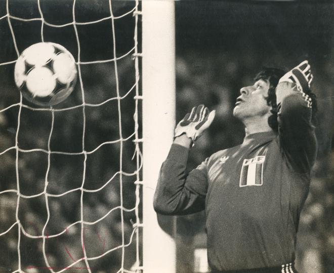 The ball slithers into the net off a shot by Leopoldo Luque of Argentina and Peru’s goalkeeper Ramon Quiroga looks back in anguish. The home team won by a huge margin of 6-0.