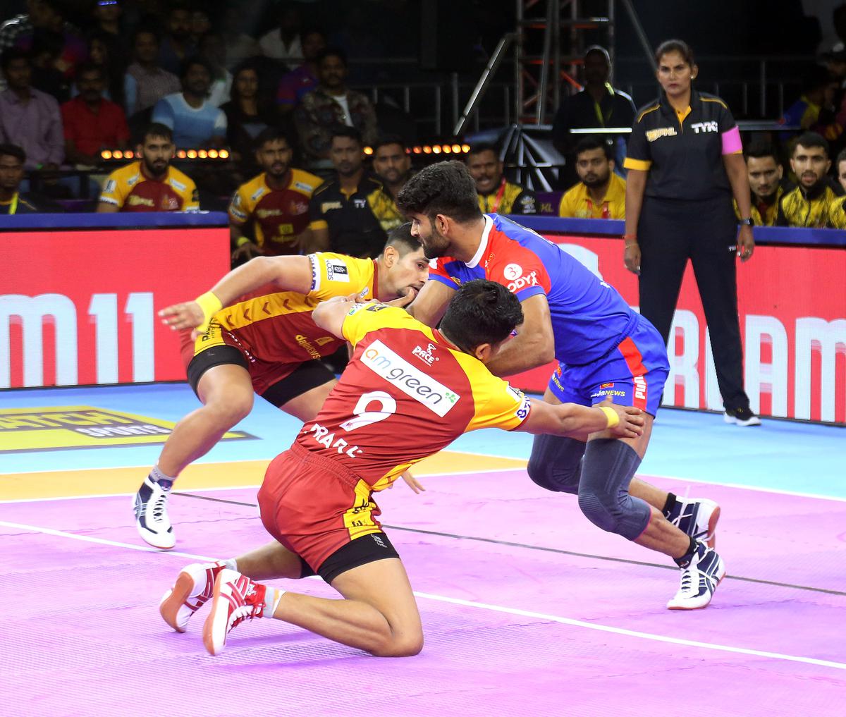 Telugu Titans defenders in action against Haryana Steelers’ raider Vinay.