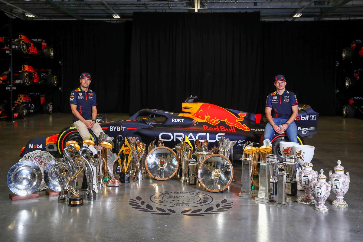 FILE PHOTO: Sergio Perez of Mexico and Oracle Red Bull Racing (L) and Max Verstappen of the Netherlands and Oracle Red Bull Racing pose for a photo with trophies at Red Bull Racing Factory.