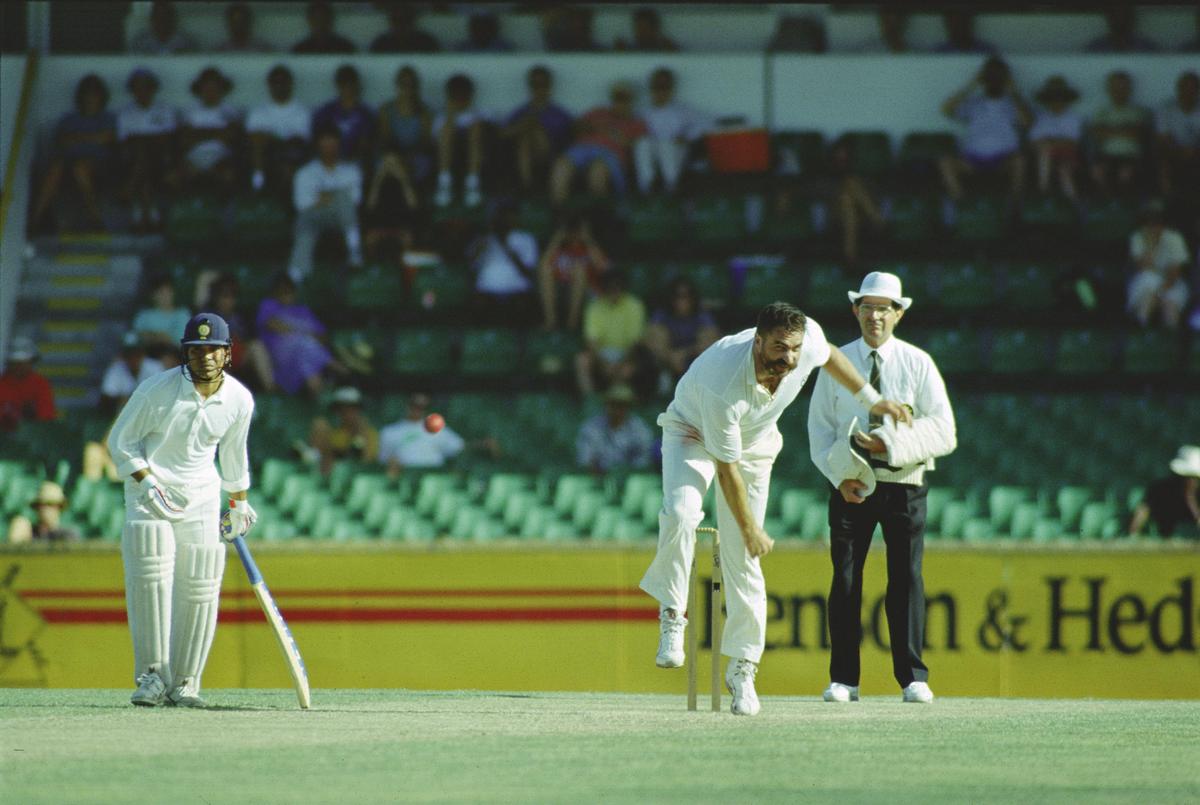 Australia's Merv Hughes bowls to Mohammed Azharuddin as non-striker Sachin Tendulkar looks on in Perth on February 2, 1992.