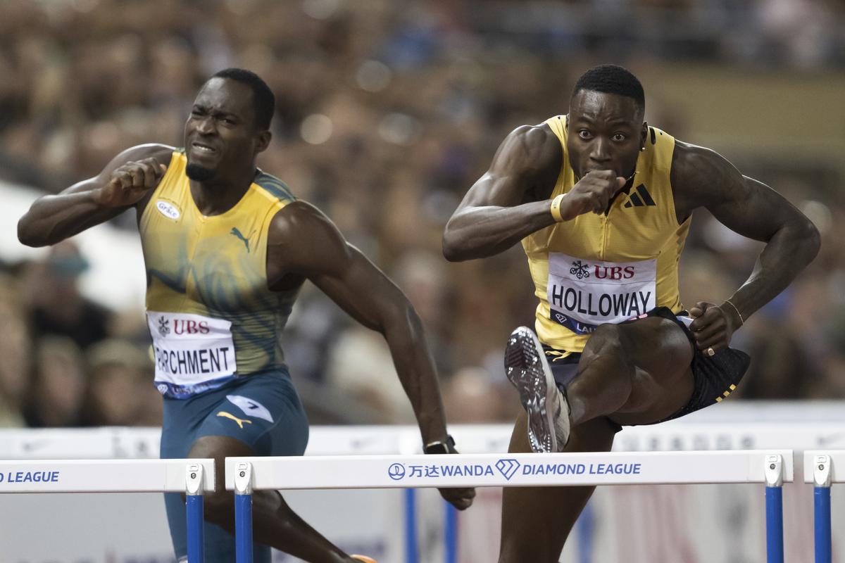 Grant Holloway of the U.S, right, and Hansle Parchment of Jamaica compete in the 110m Hurdles Men during the World Athletics Diamond League Athletissima athletics meeting at the Stade Olympique de la Pontaise in Lausanne, Switzerland, Thursday, Aug. 22, 2024. 