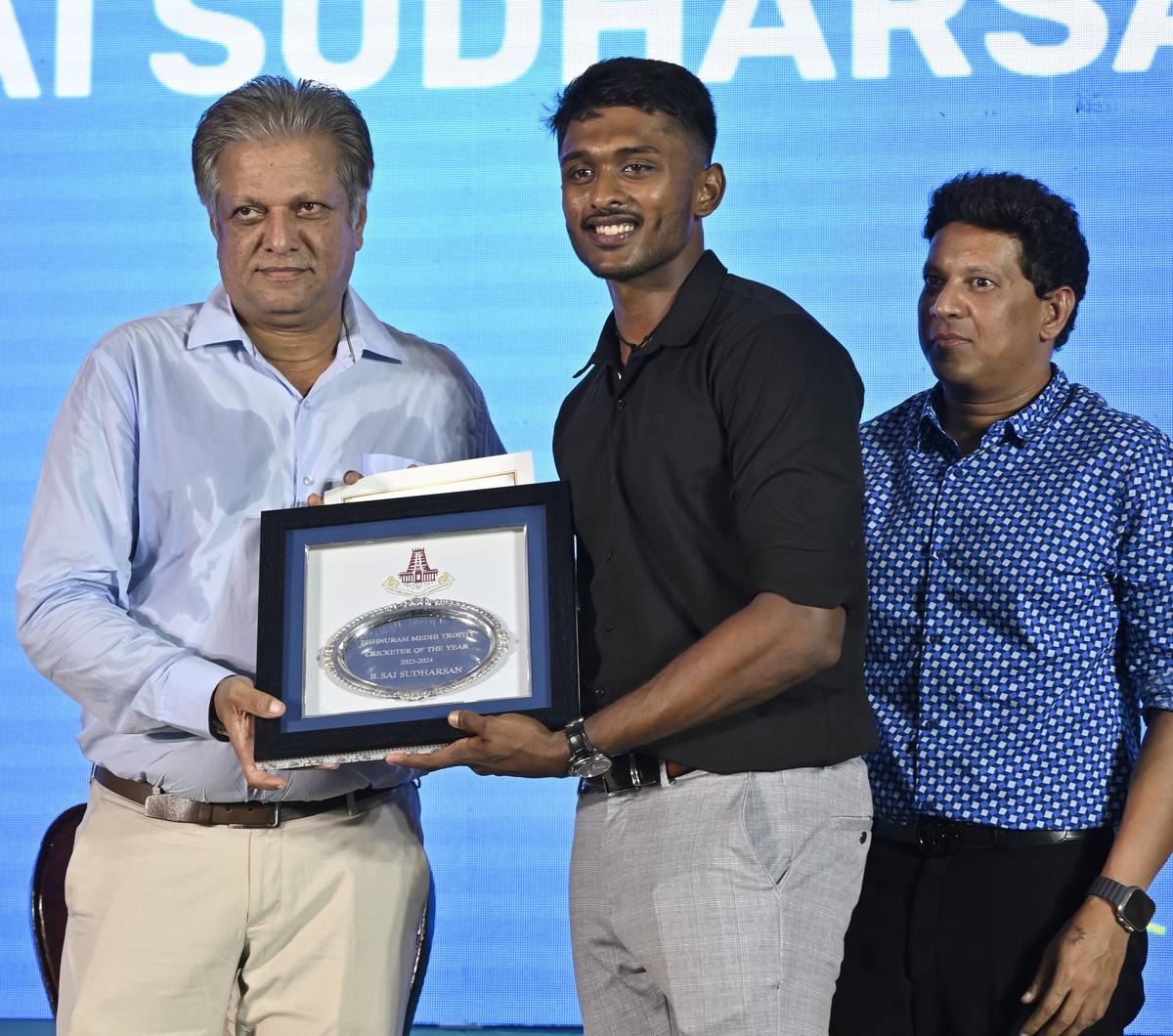 B. Sai Sudharsan (centre) receives the Bishnuram Medhi Trophy for the Cricketer of the Year 2023-24 from former India cricketer W.V. Raman (left) at the 92nd TNCA annual day celebrations in Chennai on Saturday. Dr P Ashok Sigamani (right), President, TNCA also seen in the picture. 