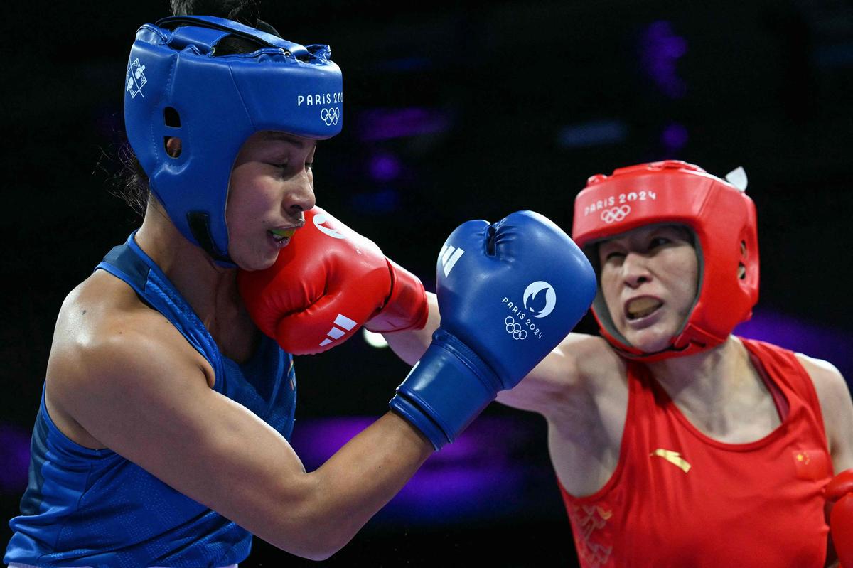 China’s Li Qian and India’s Lovlina Borgohain (Blue) during the women’s 75kg quarter-final boxing match. 