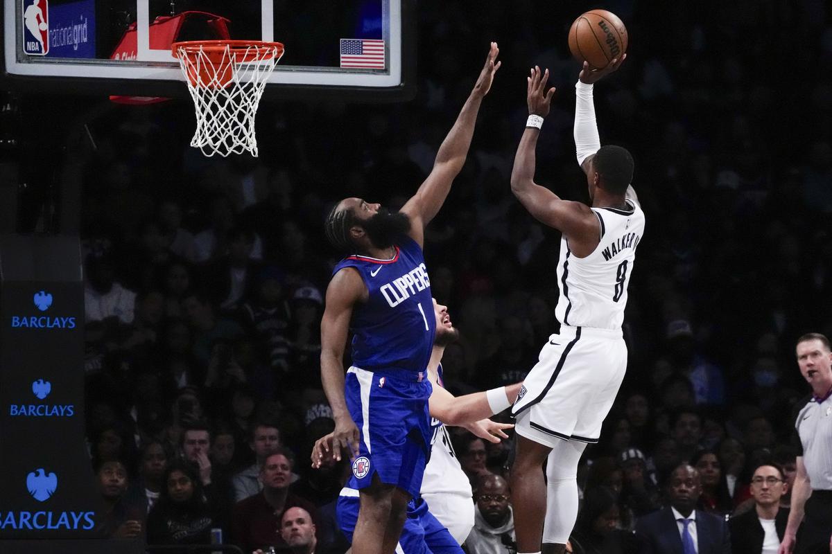 Brooklyn Nets’ Lonnie Walker IV (8) shoots over LA Clippers’ James Harden (1) during the second half of an NBA basketball game.