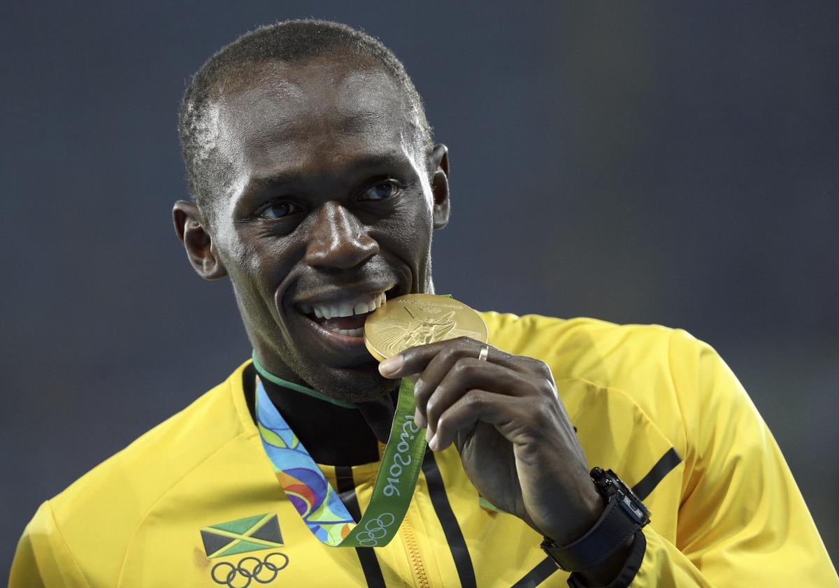 Usain Bolt poses with his gold medals after winning the men’s 4 x 100m relay at the  2016 Rio Olympics.