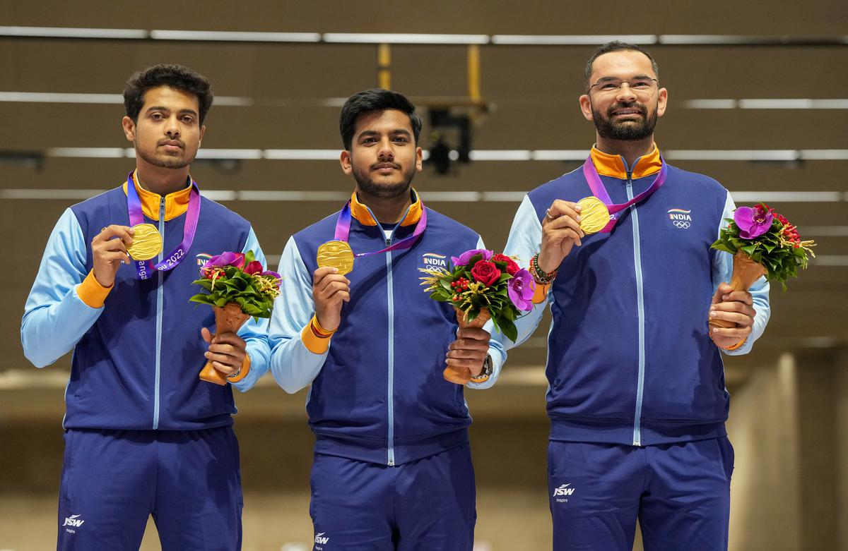 Swapnil Suresh Kusale, Aishwary Pratap Singh Tomar and Akhil Sheoran pose with their gold medal during the presentation ceremony of men’s 50m rifle 3 positions team event at the Asian Games.