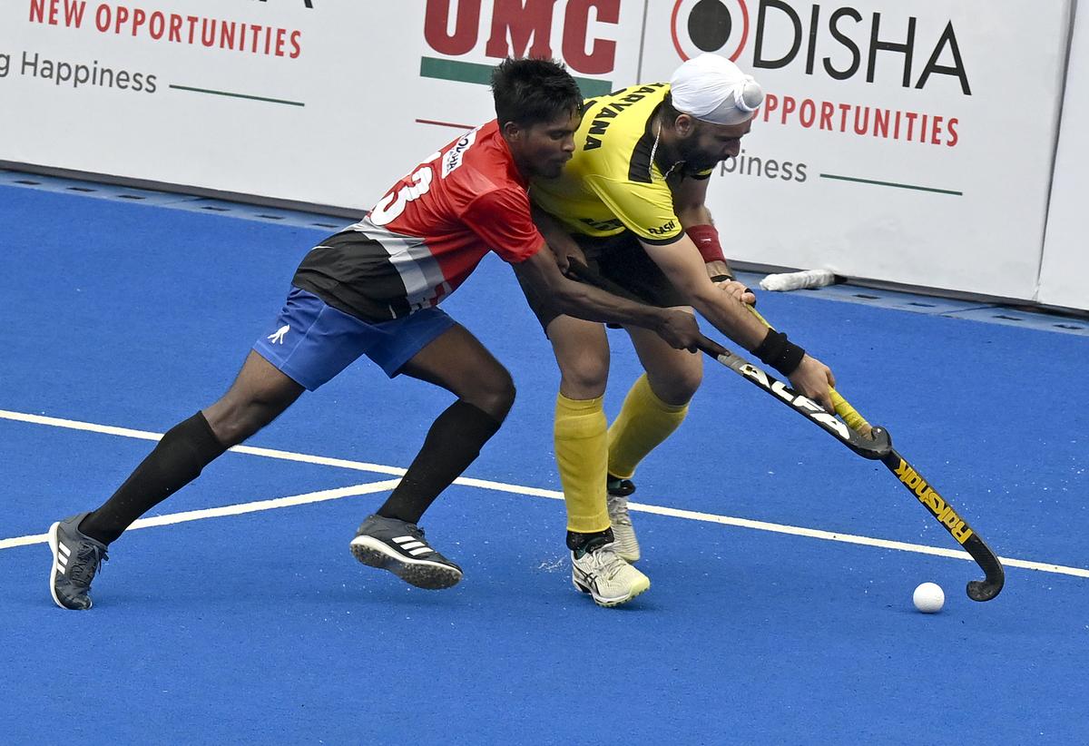 Rajinder Singh (yellow jersey) of Hockey Haryana in action against Odisha during the 14th Hockey India Senior Men National Championship at the Mayor Radhakrishnan Stadium in Chennai on Saturday.