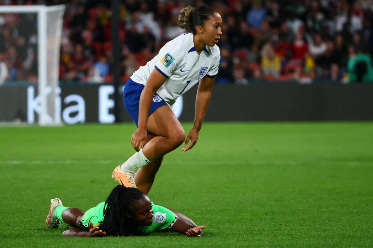 Nigeria’s defender #22 Michelle Alozie (lower) reacts after being fouled by England’s forward #07 Lauren James during the Australia and New Zealand 2023 Women’s World Cup round of 16 football match between England and Nigeria at Brisbane Stadium in Brisbane on August 7, 2023. 