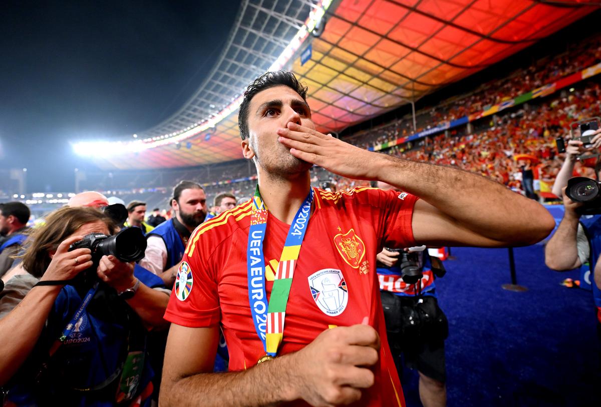 Rodri of Spain acknowledges the fans as he celebrates victory with his Winners Medal after the UEFA EURO 2024 final match between Spain and England at Olympiastadion on July 14, 2024 in Berlin, Germany.