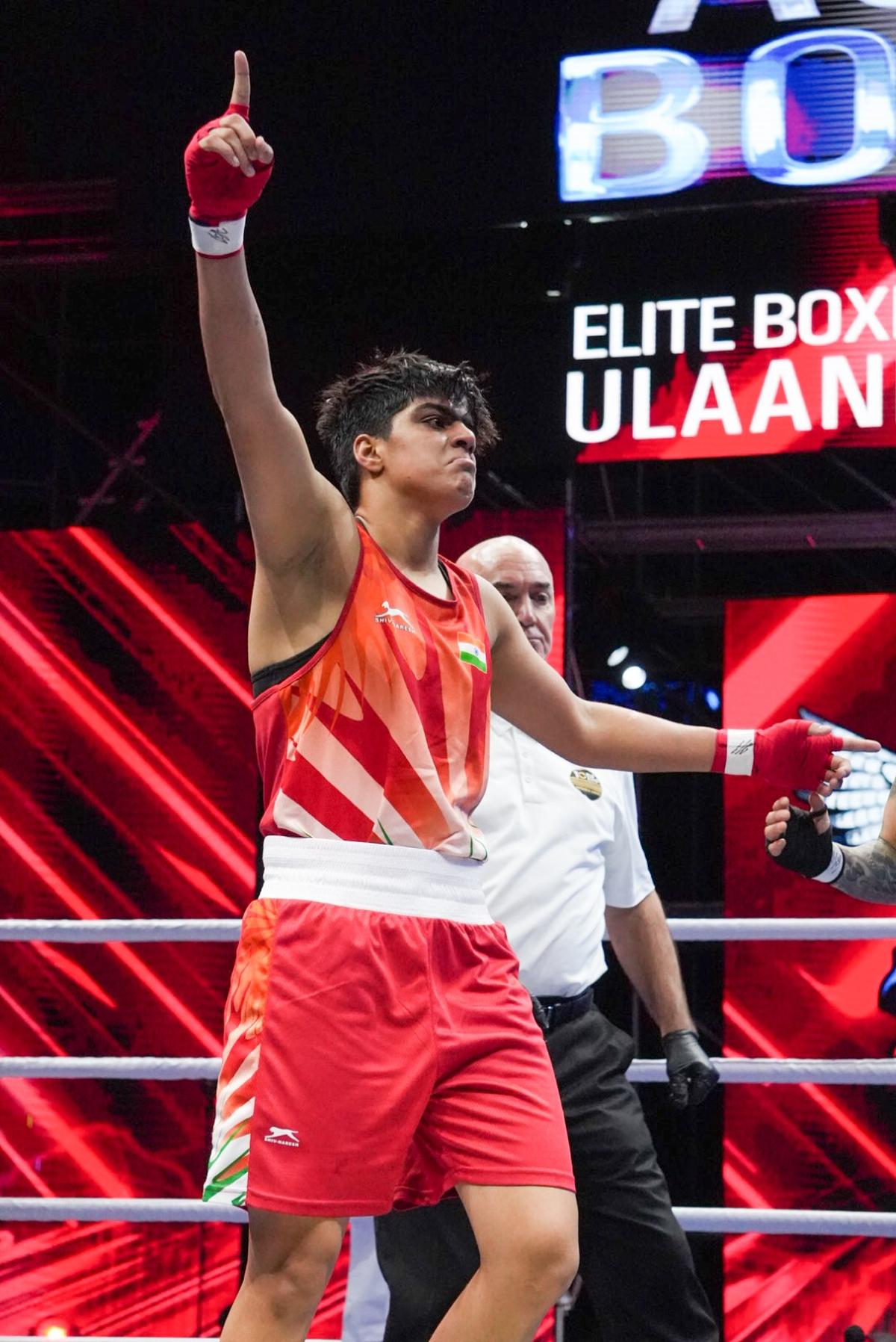 Priya celebrates her win against Chinese pugilist Yang.