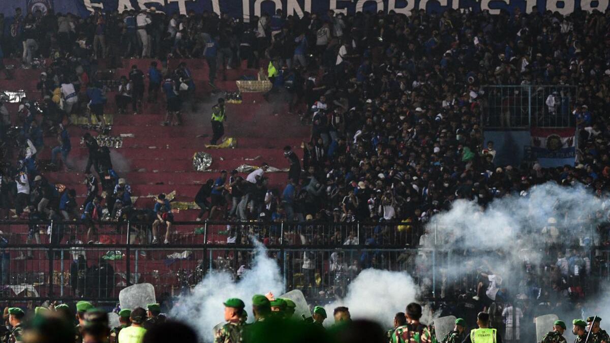 Indonesia football riot: More than 174 people killed after stampede at match