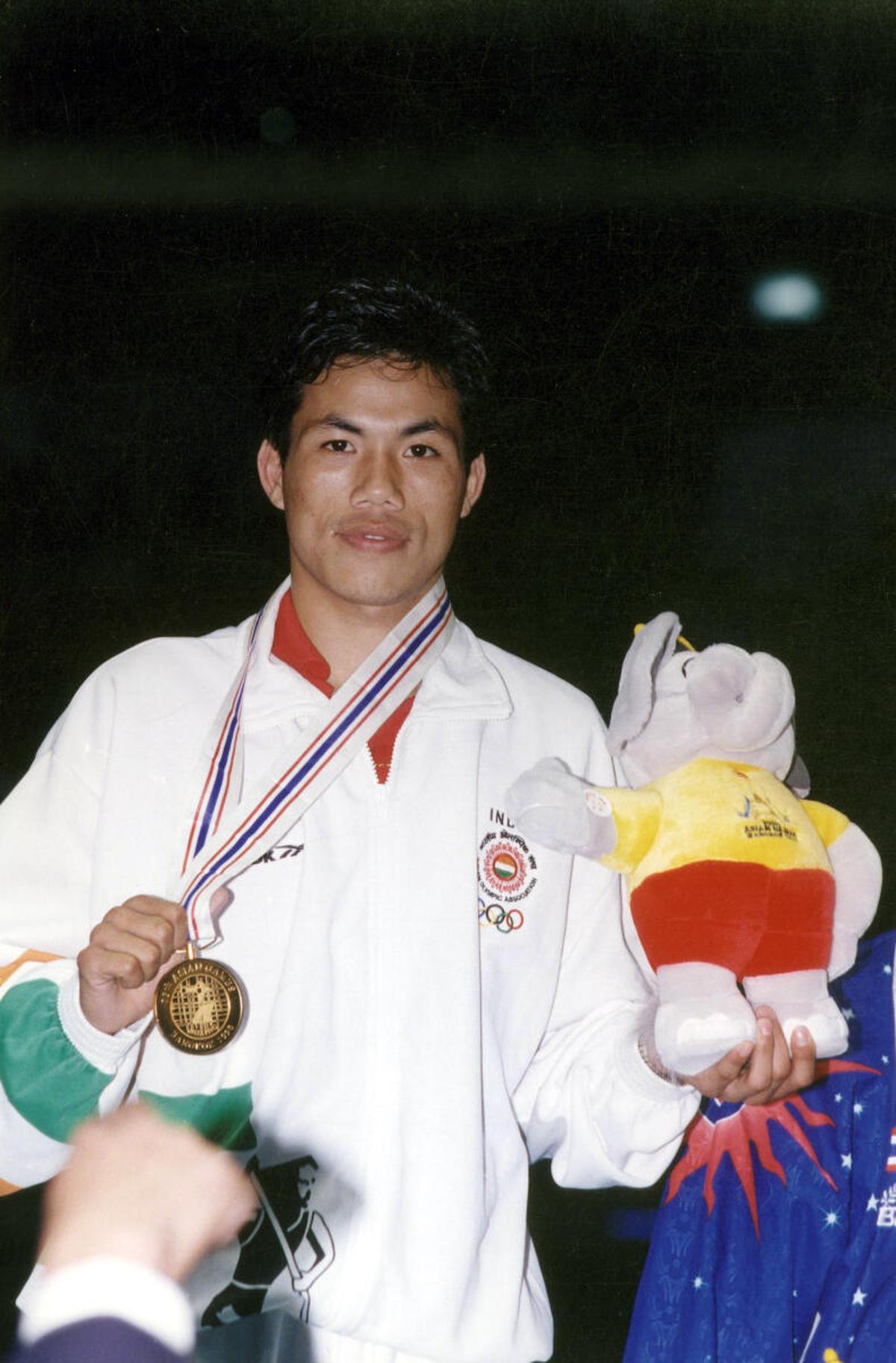 Indian boxer Dingko Singh poses with the gold medal and the mascot after winning the 54 kg division boxing event at presentation ceremony at the Asian Games 1998 in Bangkok, Thailand on December 17, 1998. He beat Timur Tulyakov of Uzbekistan in the final. 