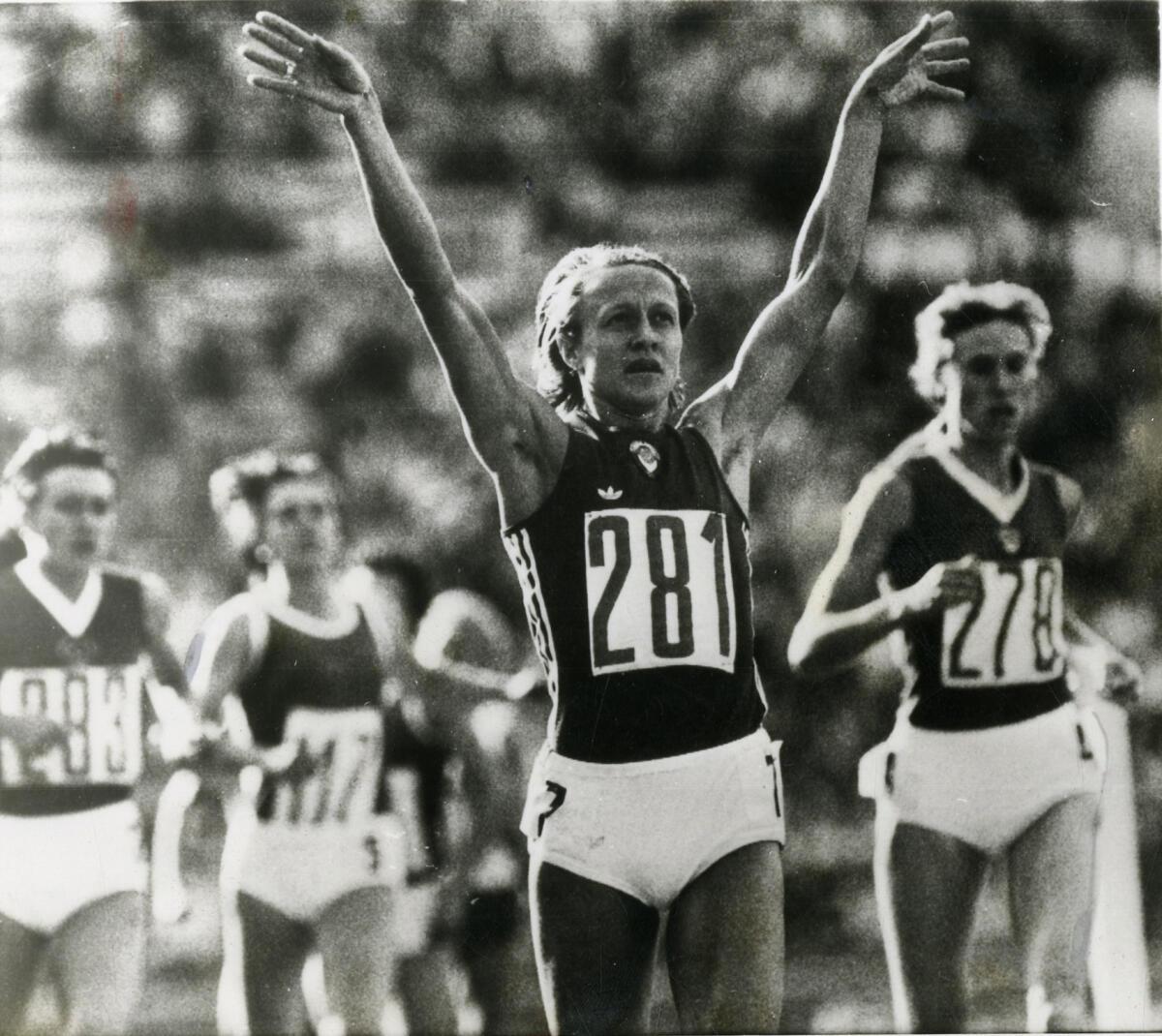 The Soviet runner Nadezhda Olizarenko raises her arms after crosssing the finish line of the 800m at the 1980 Summer Olympics.