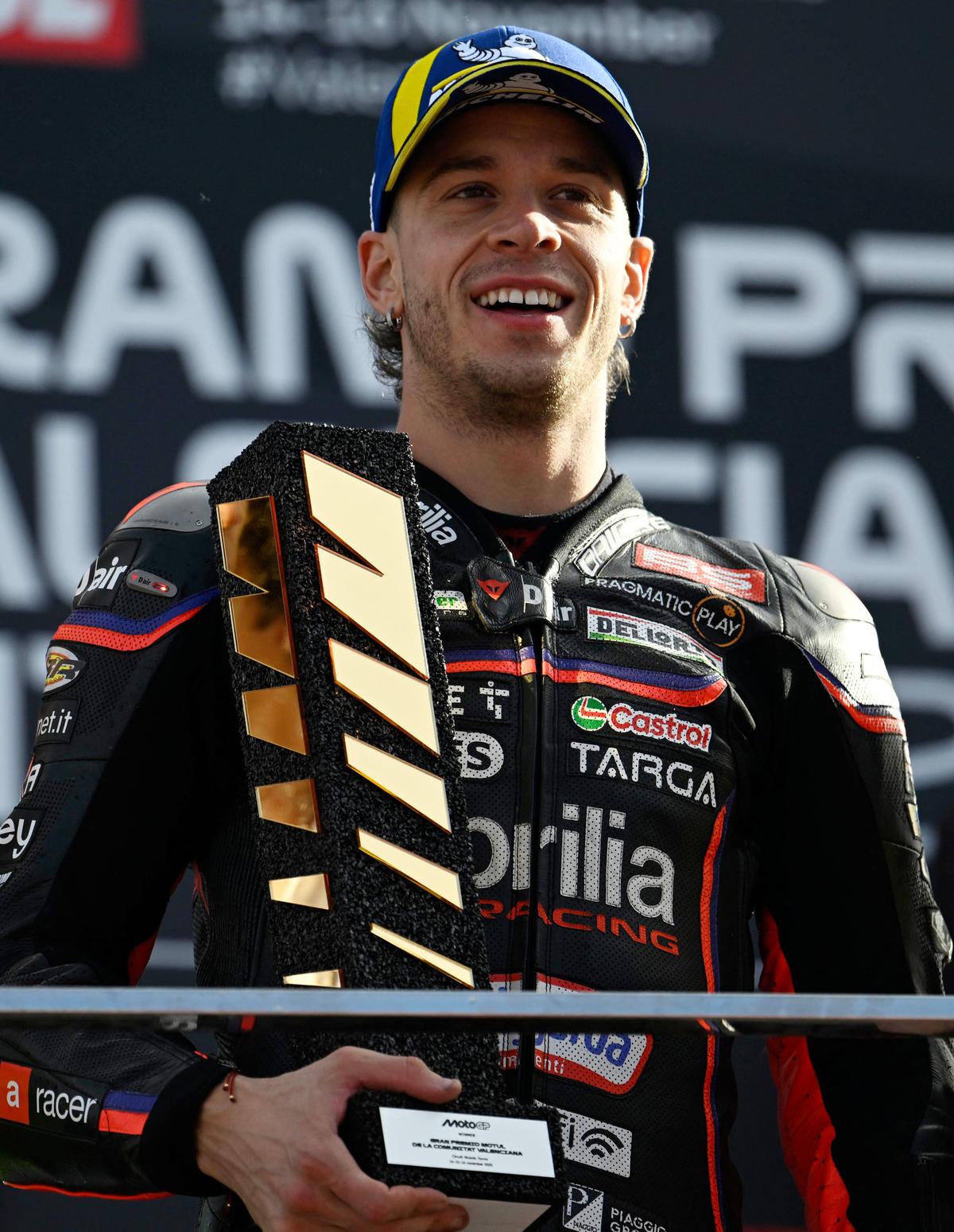 MotoGP - Valencia Grand Prix - Circuit Ricardo Tormo, Valencia, Spain - November 16, 2025
Aprilia Racing's Marco Bezzecchi celebrates on the podium after winning the MotoGp race REUTERS/Pablo Morano