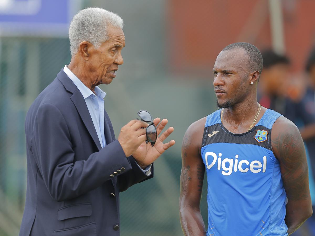 FILE PHOTO: West Indies cricket great Garfield Sobers, left, chats with batsman Jermaine Blackwood during a training session.