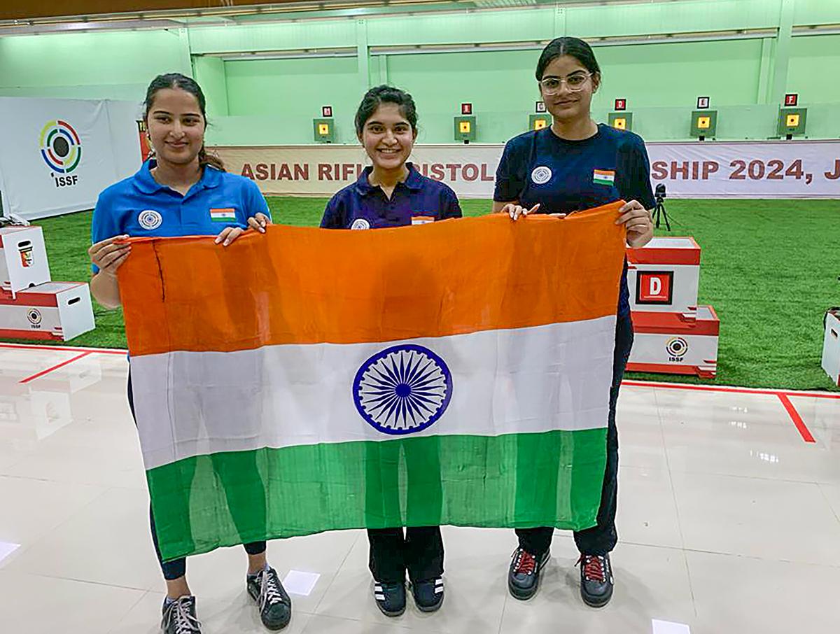 (L-R) Indian shooters Rhythm Sangwan, Esha Singh and Surbhi Rao after winning gold in the women’s 10m air pistol team event at the Asian Olympic Qualifiers. 