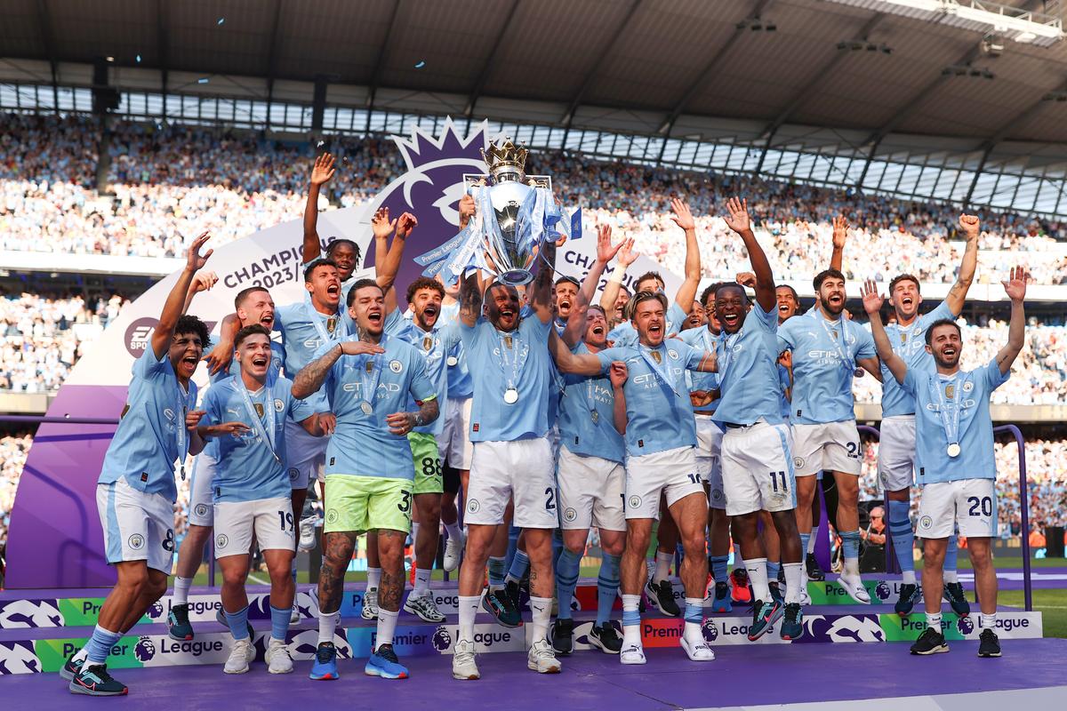 Kyle Walker of Manchester City lifts the Premier League Trophy after their team’s victory during the Premier League match between Manchester City and West Ham United at Etihad Stadium on May 19, 2024 in Manchester, England. 
