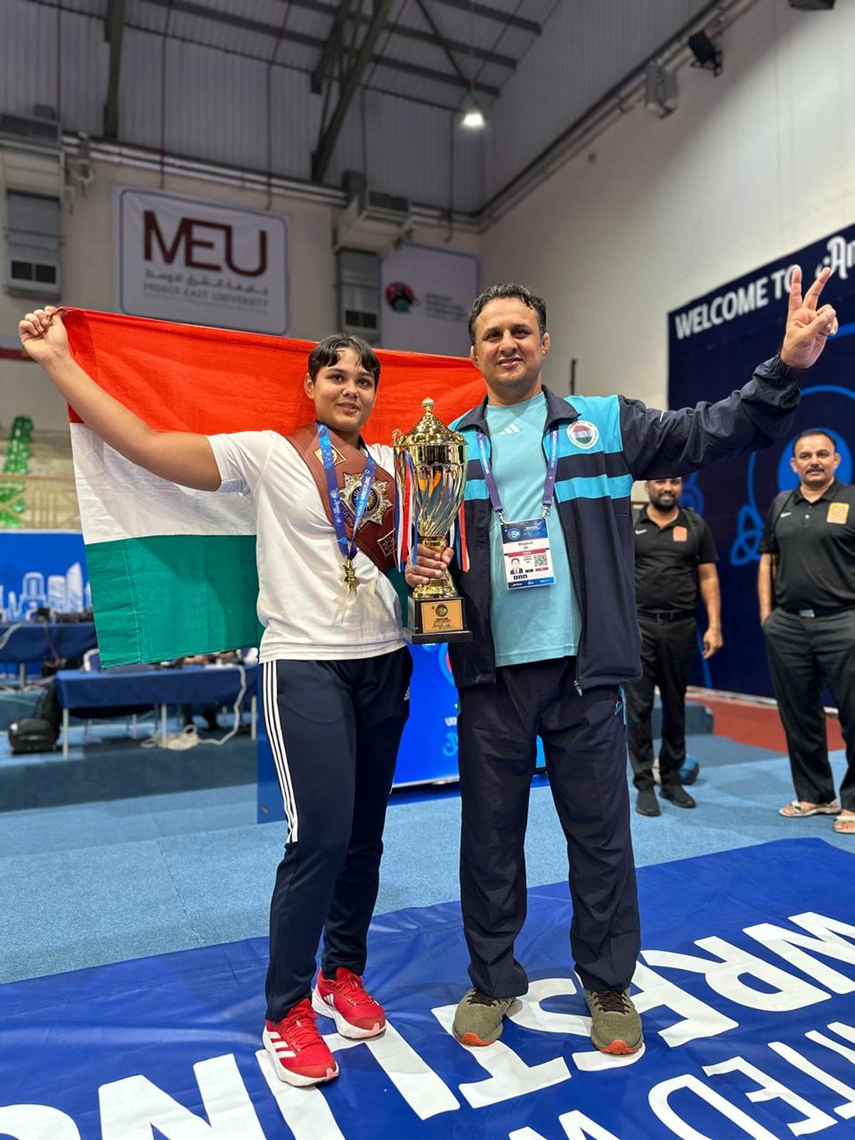 Mansi Lather celebrating her 73kg title win with father, Jai Bhagwan. 