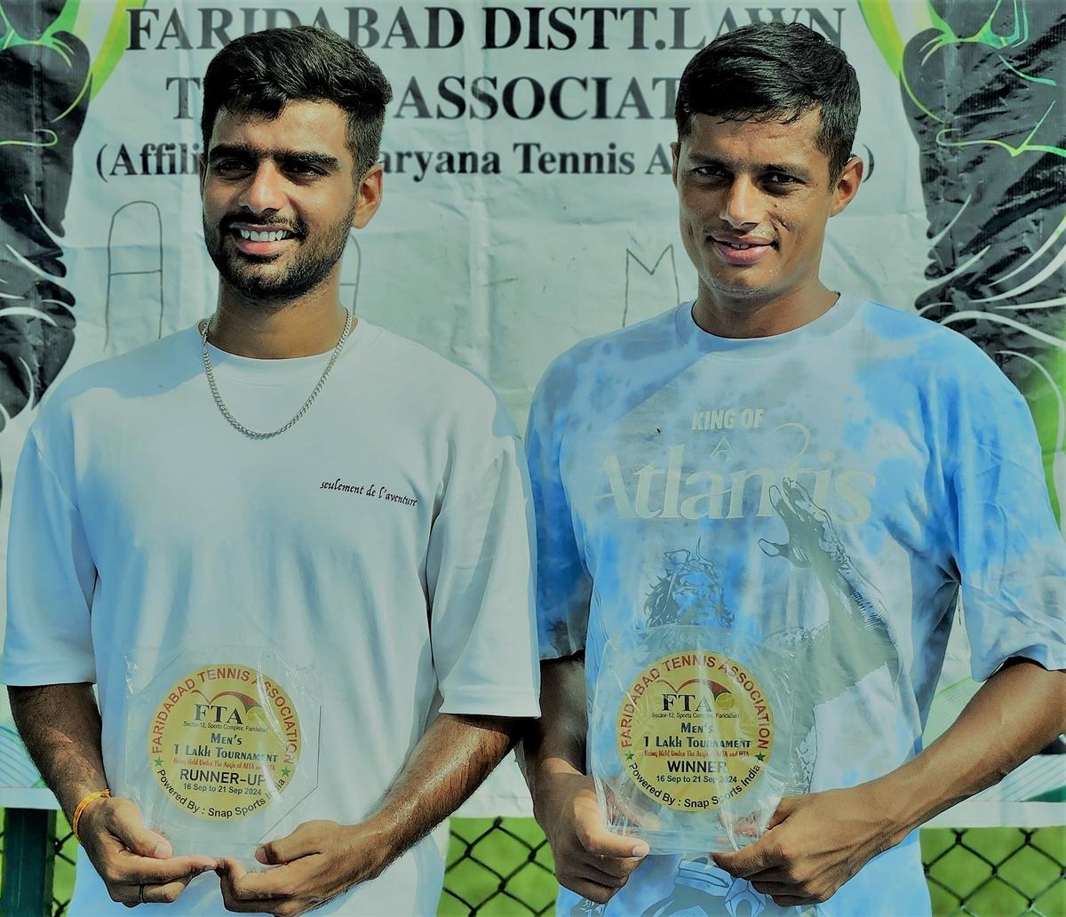 Ajay Malik (left) and champion Sunil Malik in the AITA men’s tennis tournament in Faridabad on Friday. 