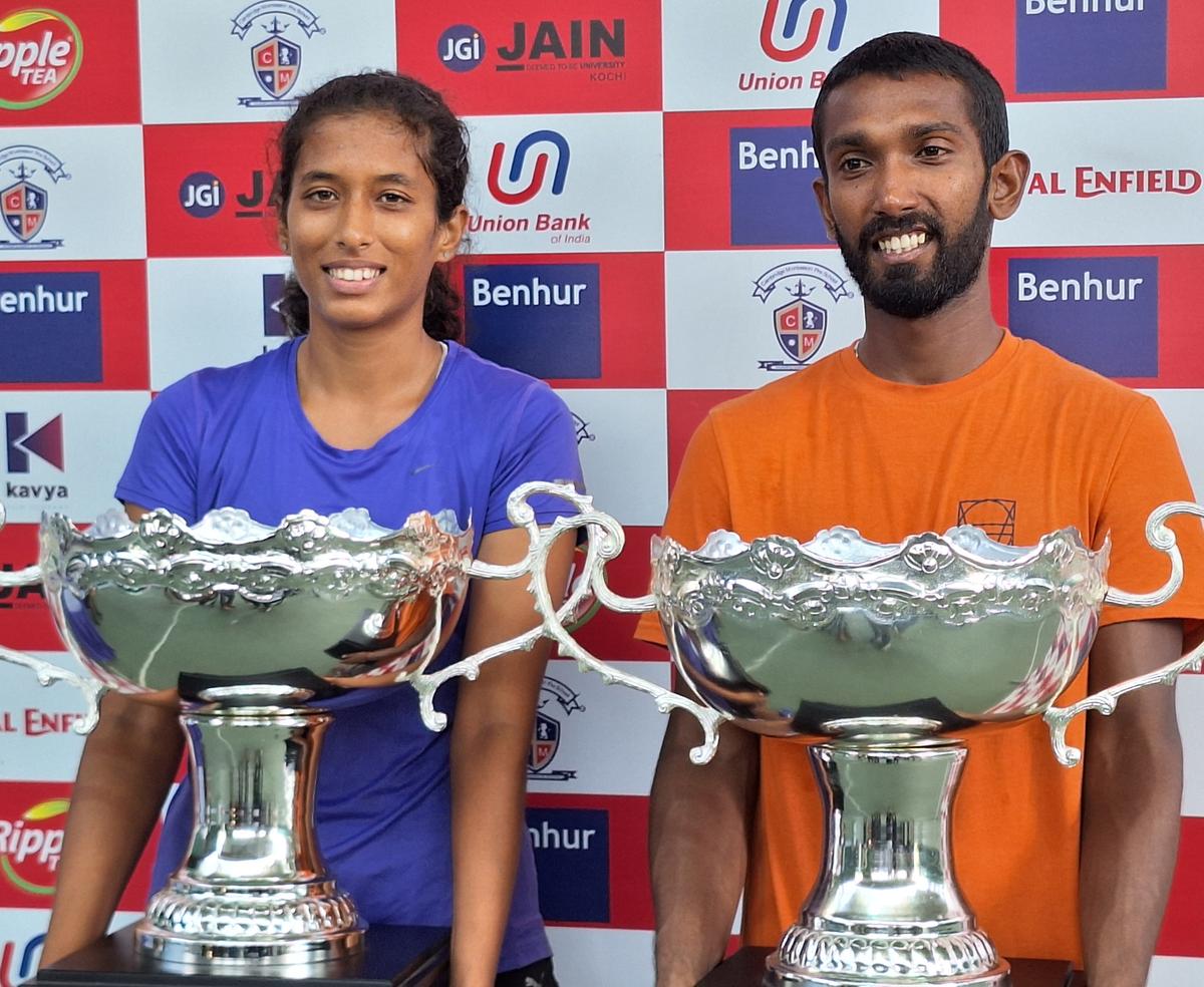 Nitin Kumar Sinha (right) and Pooja Ingale, the men’s and women’s singles champions of the National-ranking tennis tournament in Kochi on Saturday.