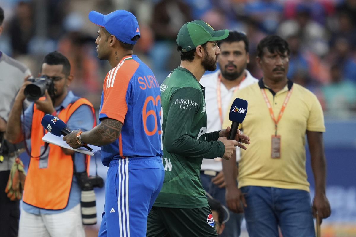 Pakistan’s captain Salman Agha, right, walks past India’s captain Suryakumar Yadav after the toss, without shaking hands, before the Asia Cup group stage match, at Dubai International Cricket Stadium.