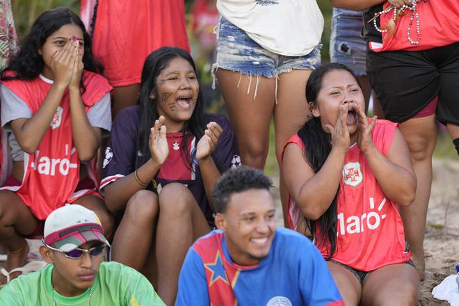 Spectators cheer as athletes compete in a soccer match as part of the Indigenous Games, in the Tapirema community of Peruibe, Brazil, Saturday, April 22, 2023.