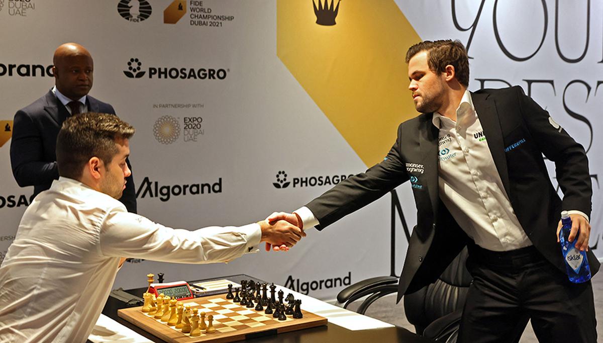 FILE PHOTO: Russia’s grandmaster Ian Nepomniachtchi and Norway’s grandmaster Magnus Carlsen play game nice during the FIDE World Chess Championship Dubai 2021,.