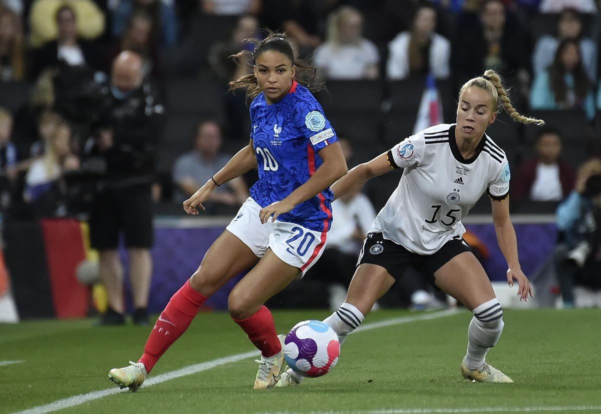 FILE PHOTO: France’s Delphine Cascarino, left, duels for the ball with Germany’s Giulia Gwinn during the Women Euro 2022 semi-final match between Germany and France.