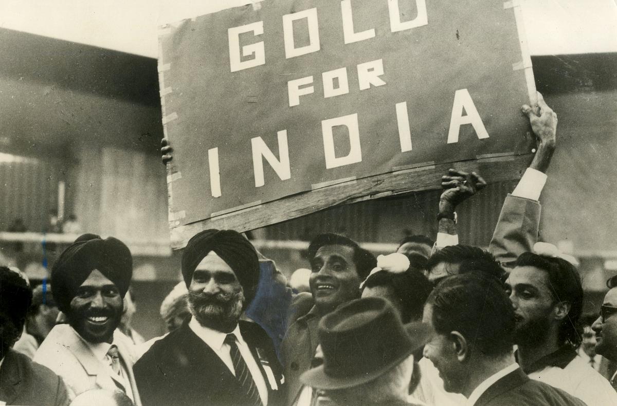 The Indian Olympic team members and fans celebrate with sign at India-Pakistan hockey match final during the Tokyo Olympic Games in 1964.