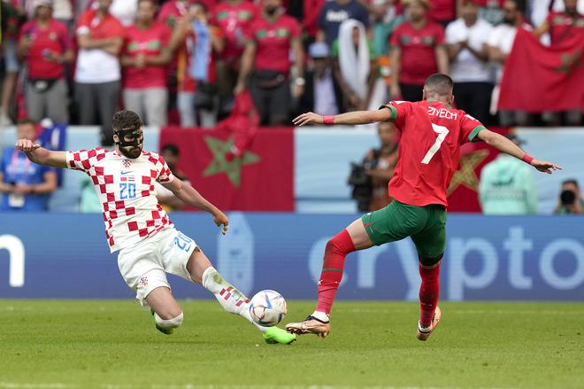 Croatia’s Josko Gvardiol, left, and Morocco’s Hakim Ziyech compete for possession throughout the World Cup group F match in Qatar.