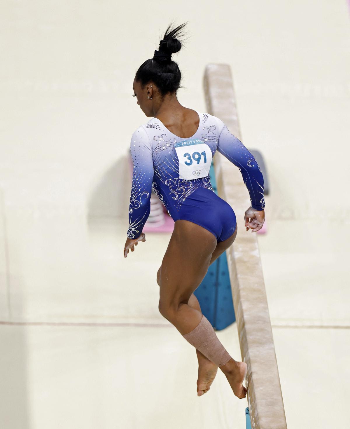 .Simone Biles of United States falls off during her balance beam.