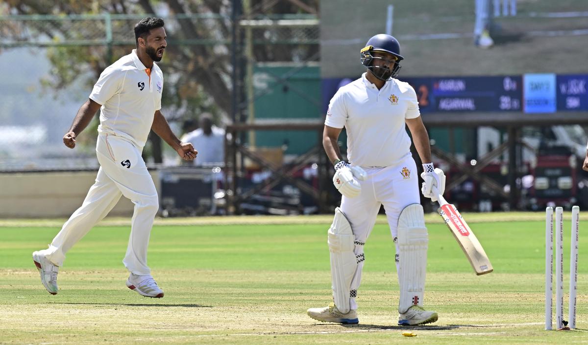 Jammu and Kashmir's Auqib Nabi, left, celebrates the wicket of Karnataka's Karun Nair on day three of the Ranji final.