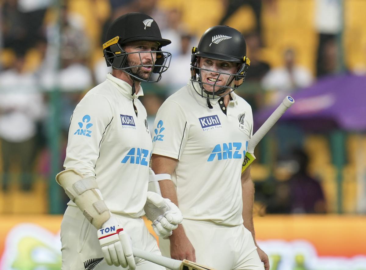 New Zealand’s captain Tom Latham and Devon Conway return to pavilion after bad light stopped play on the fourth day.