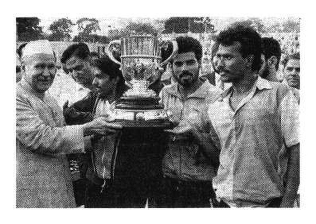 The Vice-President, Mr. S. D. Sharma, presenting the Durand Cup to the East Bengal team in New Delhi on Tuesday (From left) skipper Anirudh Kolay, Kuljit Singh and Mastan Ahmed.