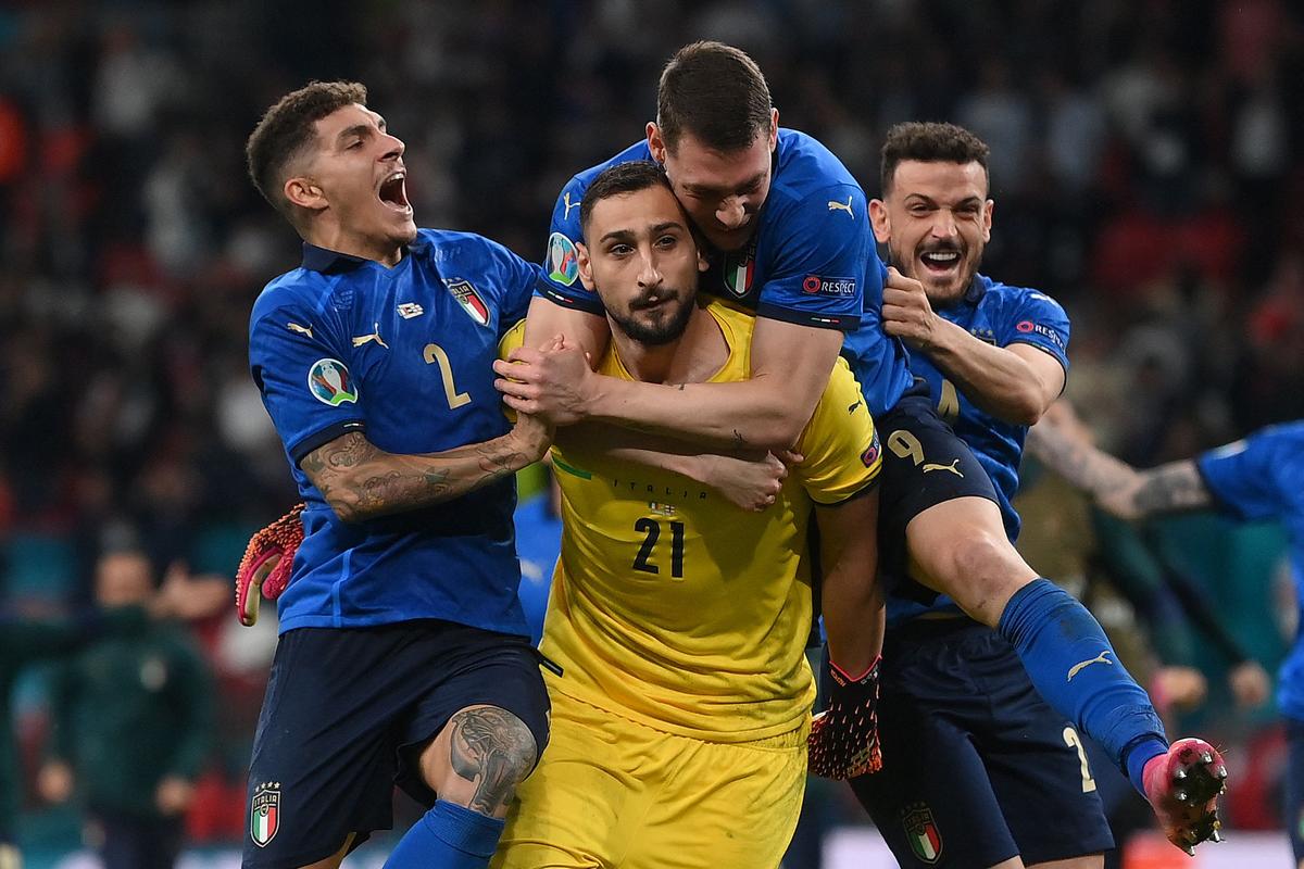 Italy’s goalkeeper Gianluigi Donnarumma (C) celebrates with teammates after winning the UEFA EURO 2020 final.