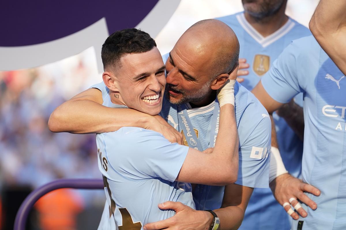 An ecstatic Pep Guardiola celebrates with Phil Foden, who was declared Player of the Season.