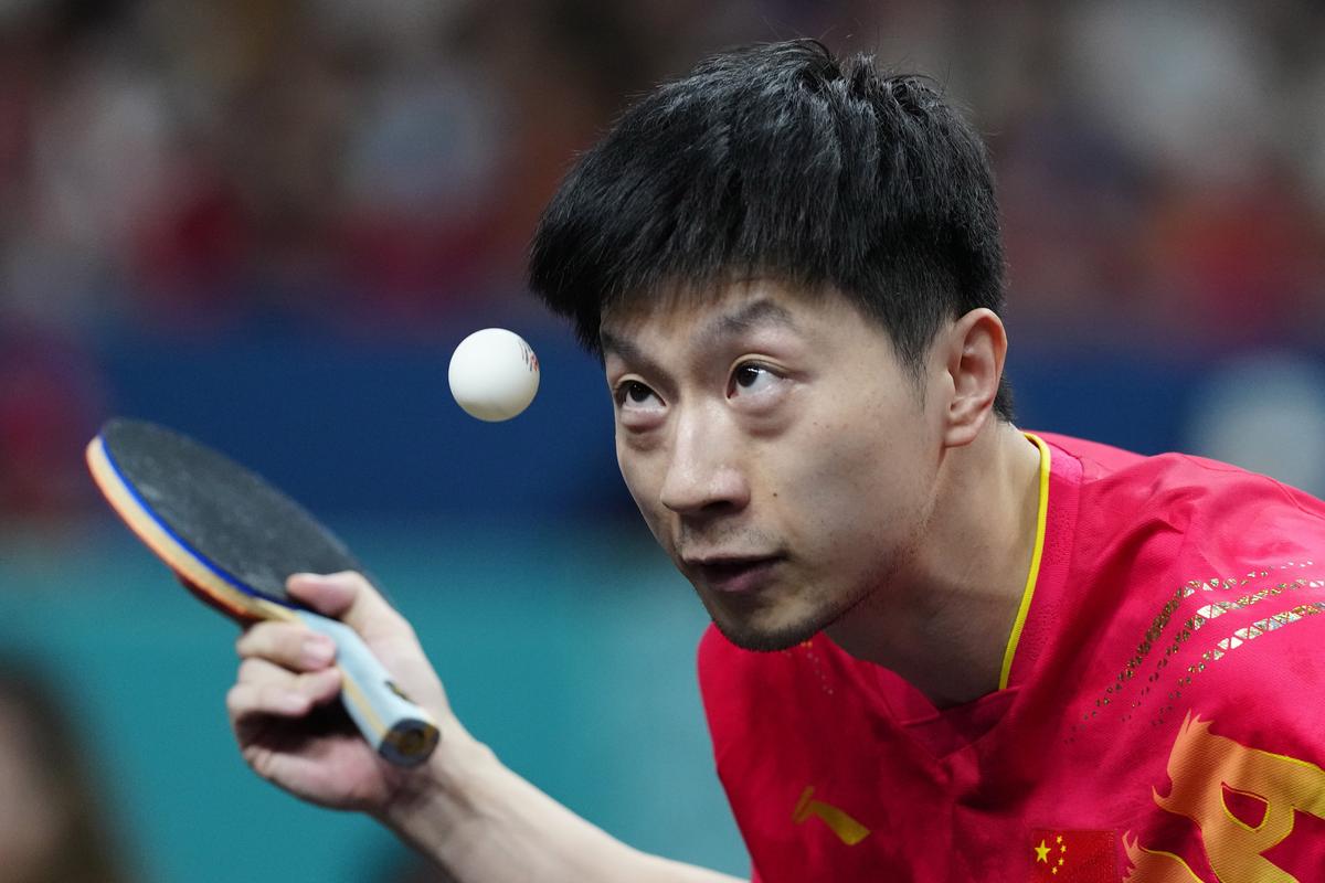 China’s Ma Long, with his teammate Wang Chuqin, plays against Sweden’s Anton Kallberg and Kristian Karlsson during the men’s gold medal team table tennis match.