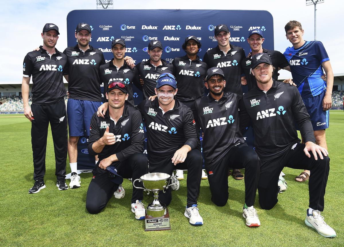 The New Zealand players pose with their trophy after winning the series against Bangladesh 2-1 after the third One Day International cricket match in Napier, New Zealand.