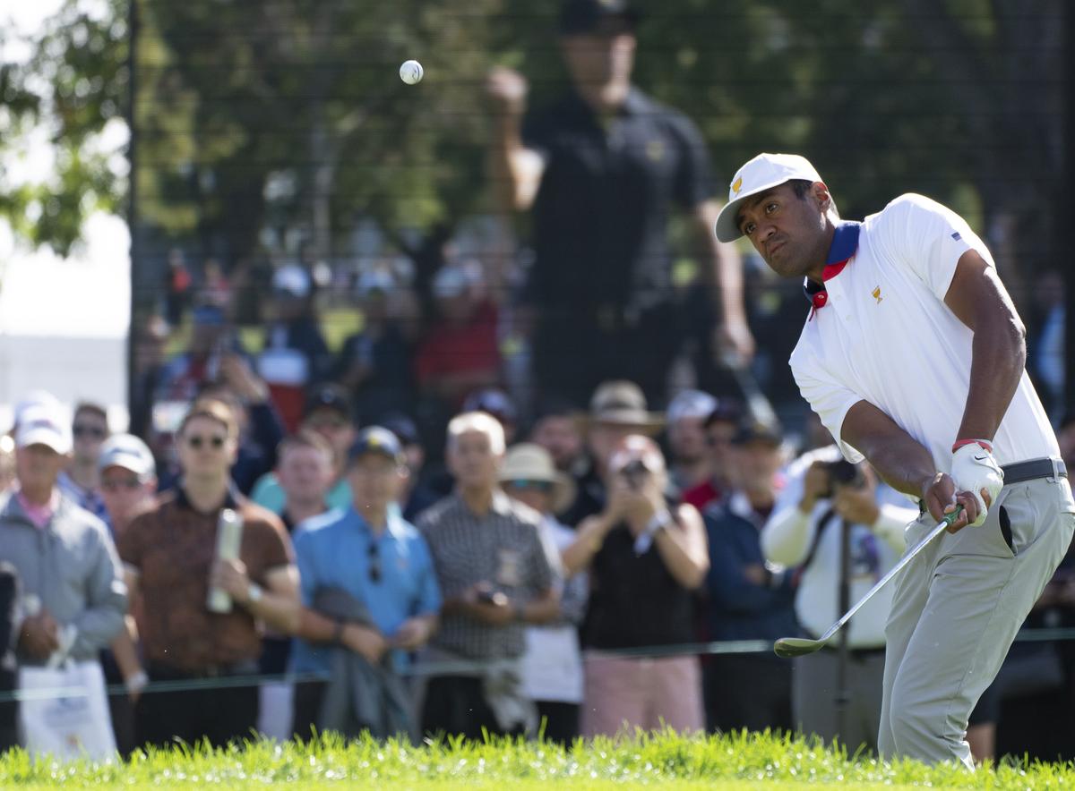 United States team member Tony Finau chips onto the green on the third hole during the second round of the Presidents Cup golf tournament at Royal Montreal Golf Club in Montreal.