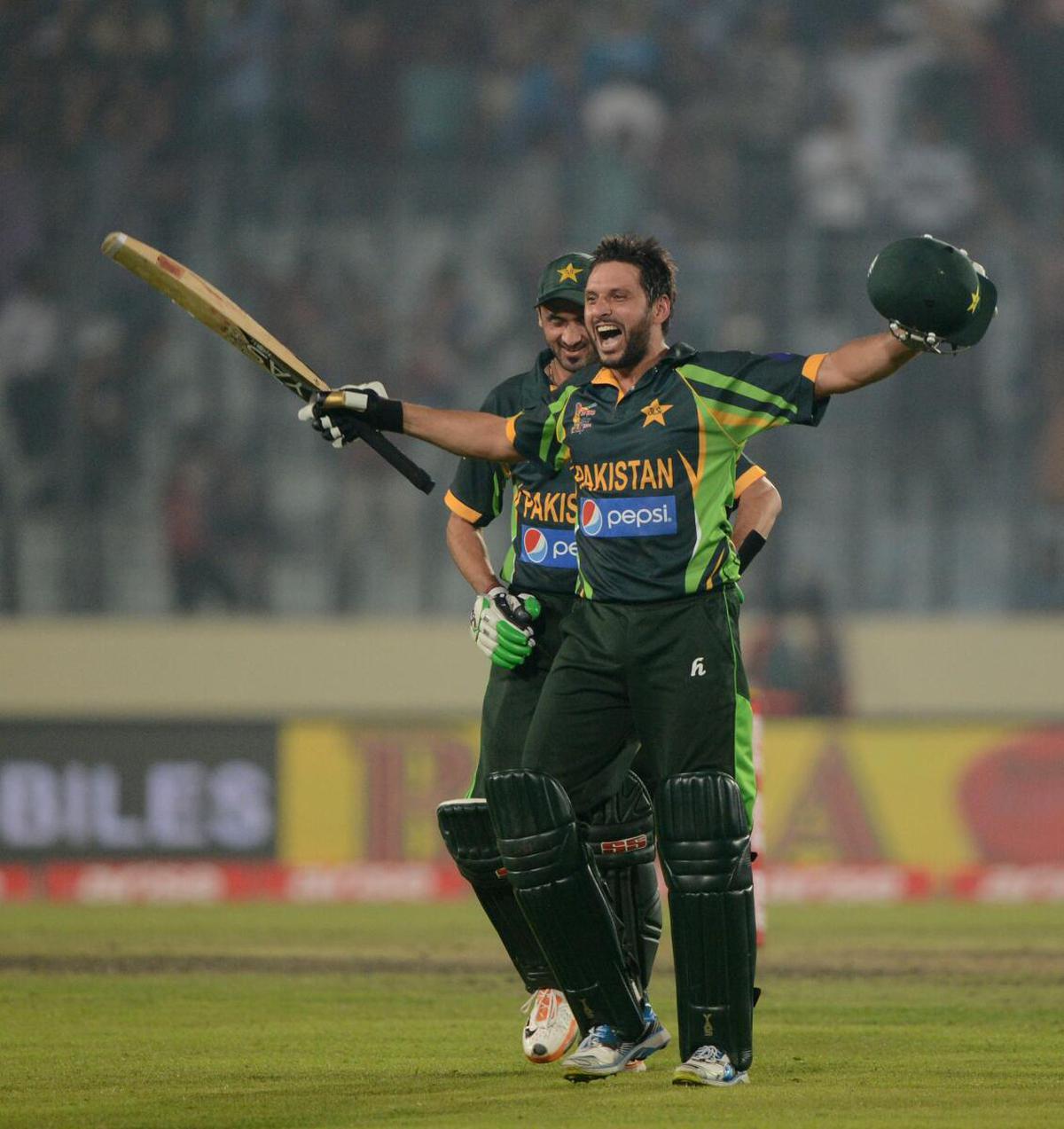 Pakistan’s Shahid Afridi and Junaid Khan react after winning the sixth match of the Asia Cup against India at the Sher-e-Bangla National Cricket Stadium in Dhaka on March 2, 2014. 